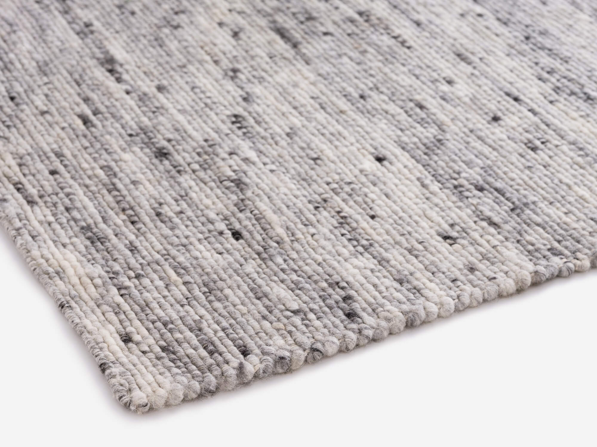 Corner detail view of light grey living room rug